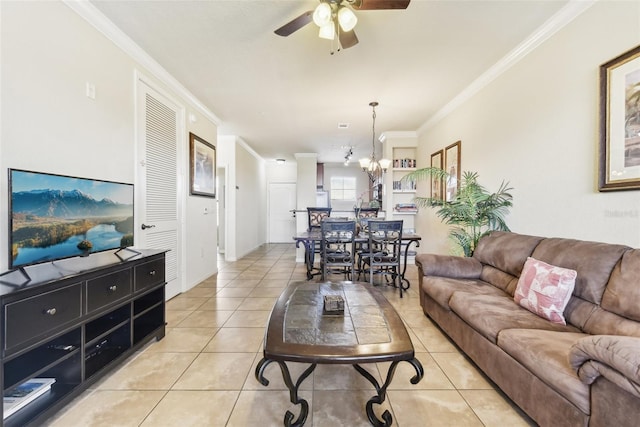 living room with light tile patterned floors, ceiling fan with notable chandelier, and crown molding