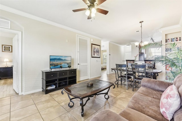 living room featuring light tile patterned floors, visible vents, ornamental molding, baseboards, and ceiling fan with notable chandelier