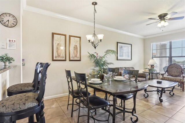 dining area with light tile patterned floors, baseboards, ornamental molding, and ceiling fan with notable chandelier