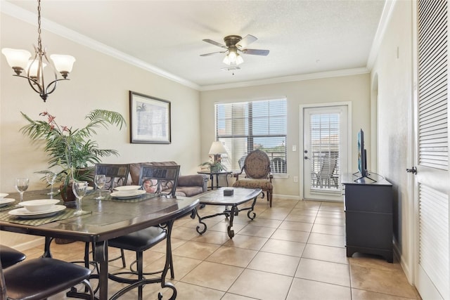 dining space with light tile patterned floors, a textured ceiling, ceiling fan with notable chandelier, baseboards, and ornamental molding