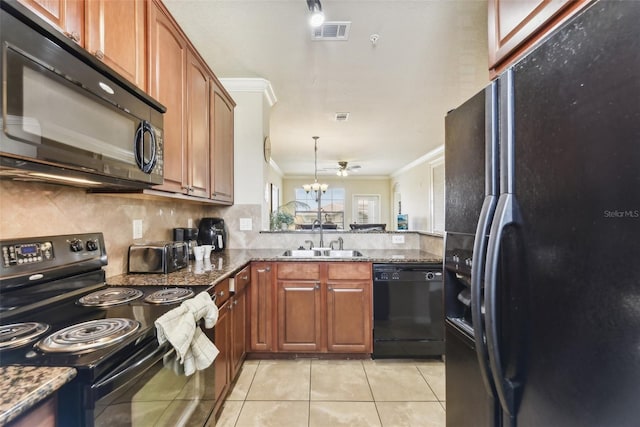 kitchen with a sink, visible vents, ornamental molding, brown cabinets, and black appliances