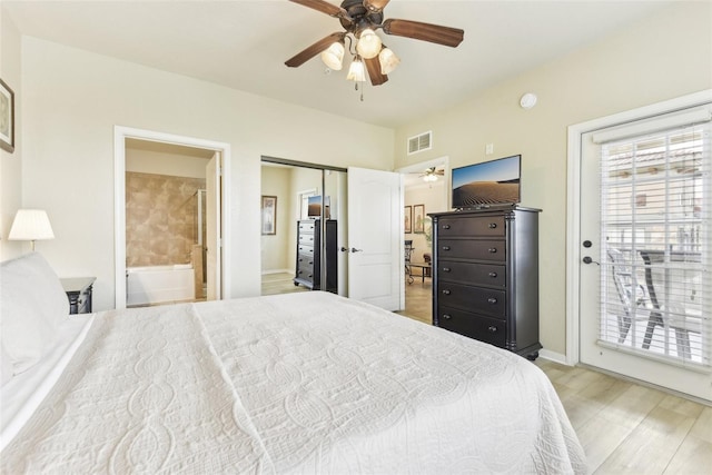 bedroom featuring visible vents, a ceiling fan, ensuite bath, access to exterior, and light wood-type flooring