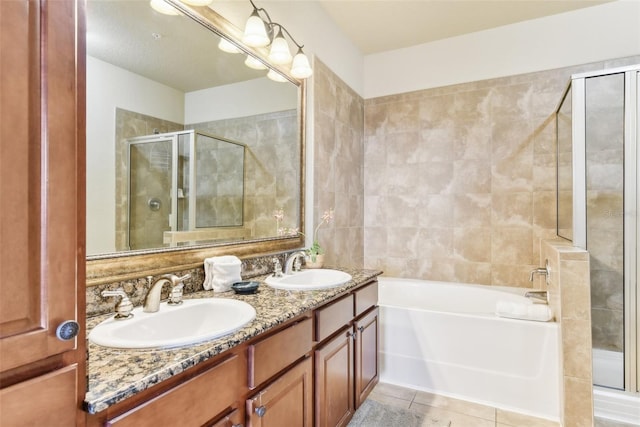 full bathroom with tile patterned flooring, a garden tub, a sink, and a shower stall