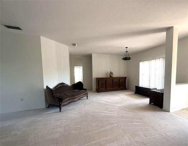 318 Rock Springs Dr, Poinciana, FL 34759 - living area featuring light carpet, baseboards, and a textured ceiling