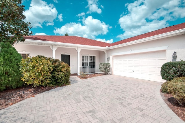 318 Rock Springs Dr, Poinciana, FL 34759 - single story home featuring decorative driveway, covered porch, stucco siding, and an attached garage