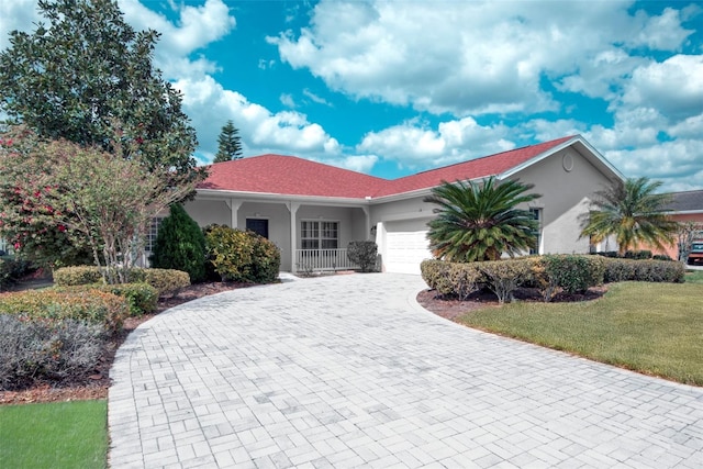 318 Rock Springs Dr, Poinciana, FL 34759 - ranch-style house with a garage, decorative driveway, a front yard, and stucco siding
