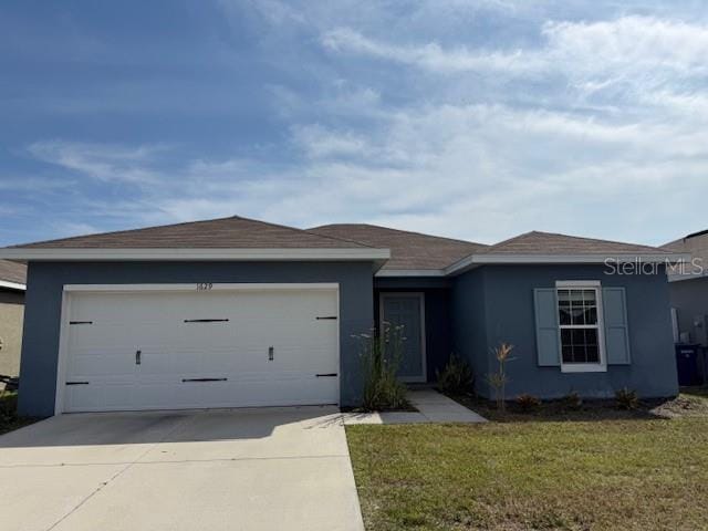 single story home with a garage, driveway, a front lawn, and stucco siding