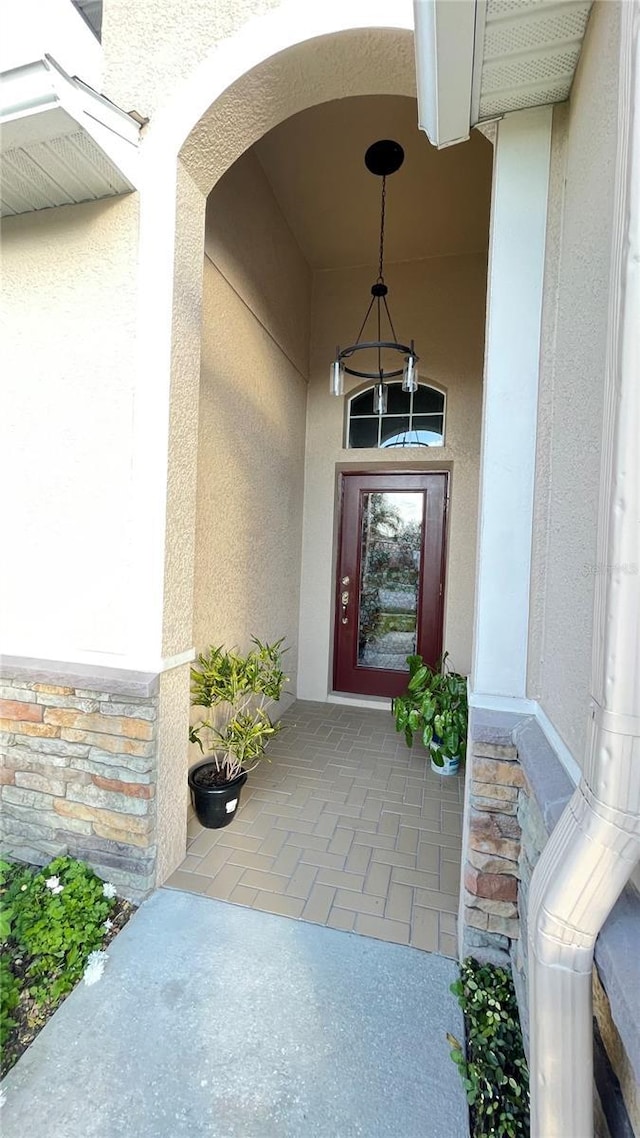 view of exterior entry featuring stucco siding