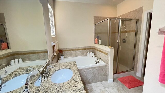 full bathroom with a stall shower, tile patterned floors, a garden tub, and vanity