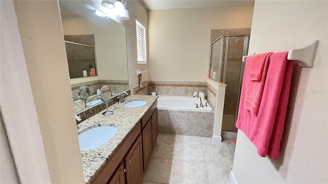 full bath with a garden tub, double vanity, a stall shower, and a sink