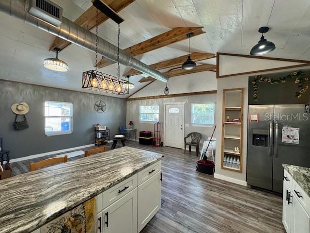 kitchen with decorative light fixtures, stainless steel refrigerator with ice dispenser, white cabinetry, and light stone countertops