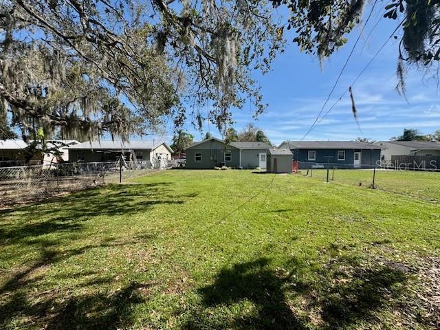 view of yard featuring fence and a residential view