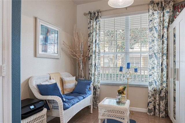 living area featuring baseboards and tile patterned floors