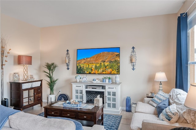 tiled living area featuring baseboards