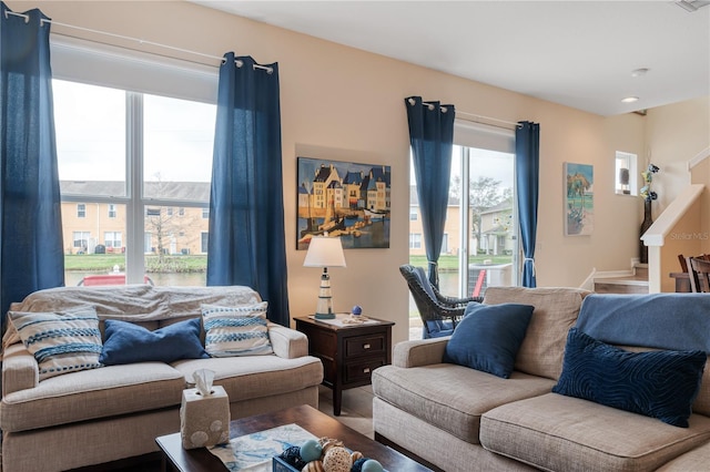 living room with visible vents and stairway