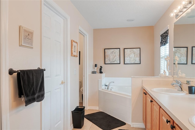 full bath with double vanity, toilet, a sink, tile patterned flooring, and a bath