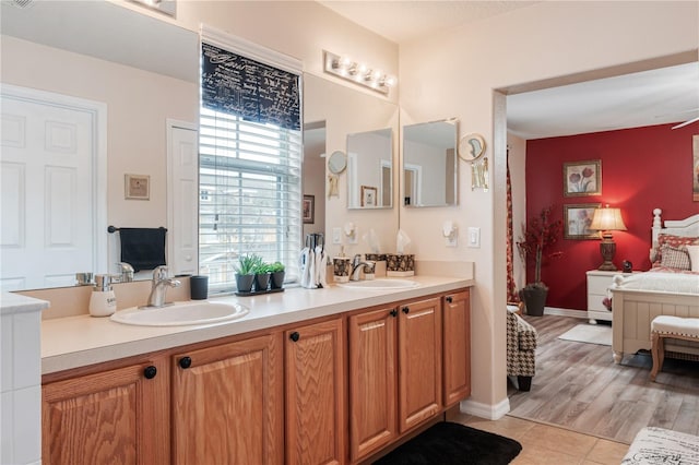 bathroom with tile patterned floors, visible vents, a sink, and double vanity