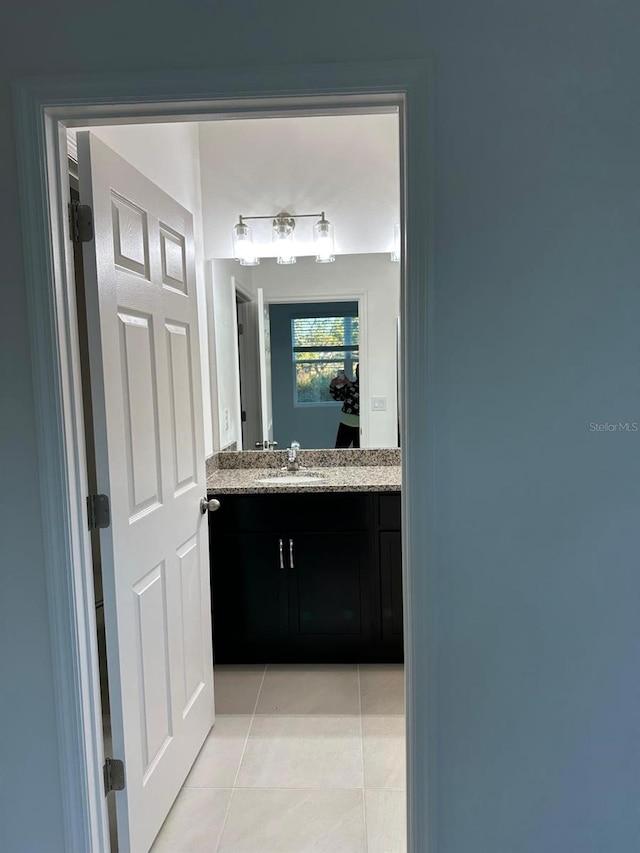 bathroom featuring tile patterned flooring and vanity