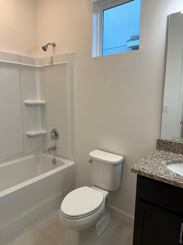 bathroom with baseboards, toilet, tile patterned floors, vanity, and washtub / shower combination