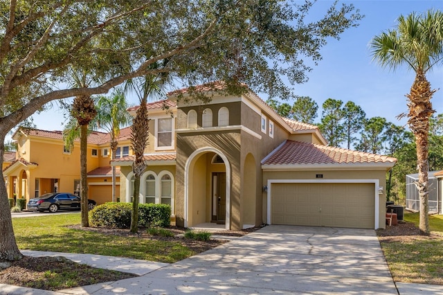 mediterranean / spanish-style house featuring a garage, concrete driveway, a tiled roof, and stucco siding