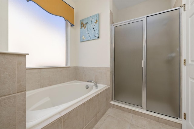 113 Tiger Lily Ct, Davenport, FL 33837 - bathroom with a shower stall, a bath, and tile patterned flooring