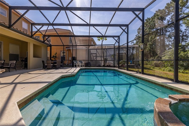 113 Tiger Lily Ct, Davenport, FL 33837 - view of pool with glass enclosure, a patio, and a pool with connected hot tub