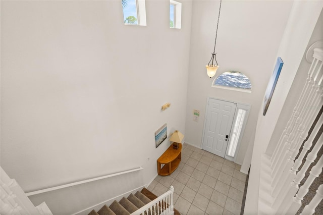 113 Tiger Lily Ct, Davenport, FL 33837 - foyer featuring stairs, light tile patterned flooring, and a high ceiling