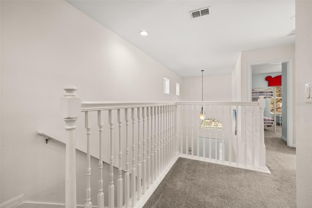 113 Tiger Lily Ct, Davenport, FL 33837 - hall with carpet floors and an upstairs landing