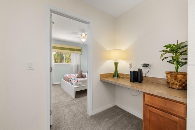 113 Tiger Lily Ct, Davenport, FL 33837 - home office with dark carpet, built in study area, baseboards, and a ceiling fan