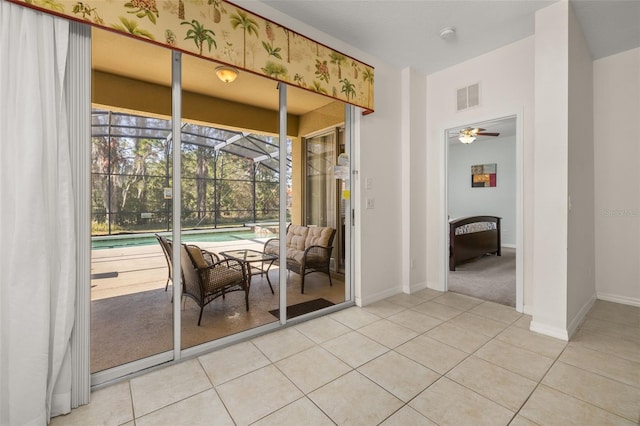 113 Tiger Lily Ct, Davenport, FL 33837 - dining area featuring a sunroom, light tile patterned flooring, ceiling fan, and baseboards