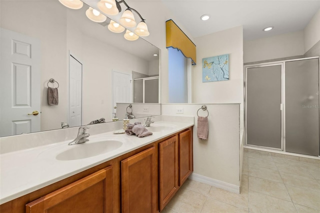 113 Tiger Lily Ct, Davenport, FL 33837 - full bath with double vanity, a shower stall, tile patterned flooring, and baseboards