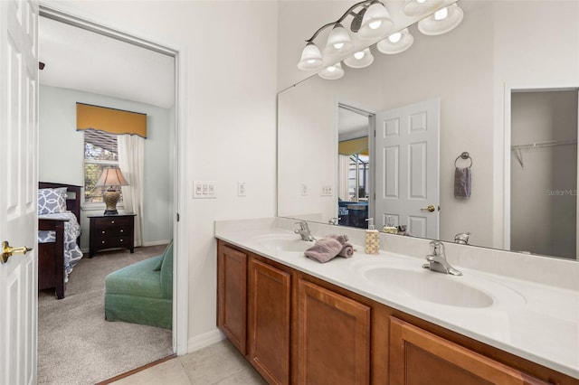 113 Tiger Lily Ct, Davenport, FL 33837 - full bath featuring ensuite bath, double vanity, tile patterned flooring, and baseboards