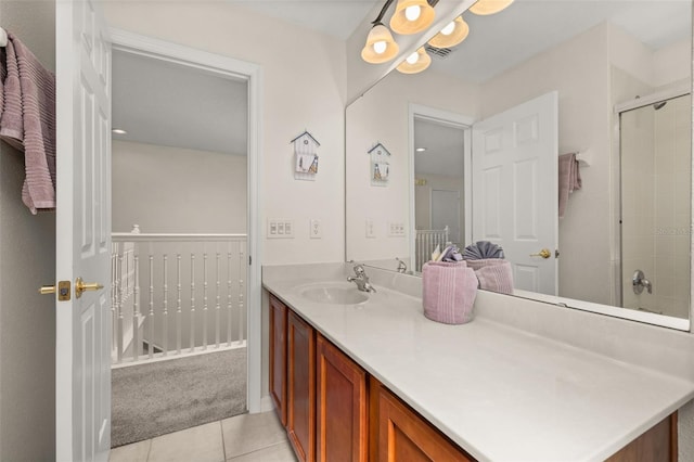 113 Tiger Lily Ct, Davenport, FL 33837 - bathroom featuring vanity, tile patterned flooring, and a tile shower