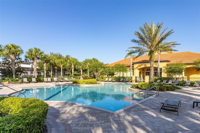 113 Tiger Lily Ct, Davenport, FL 33837 - community pool featuring a patio