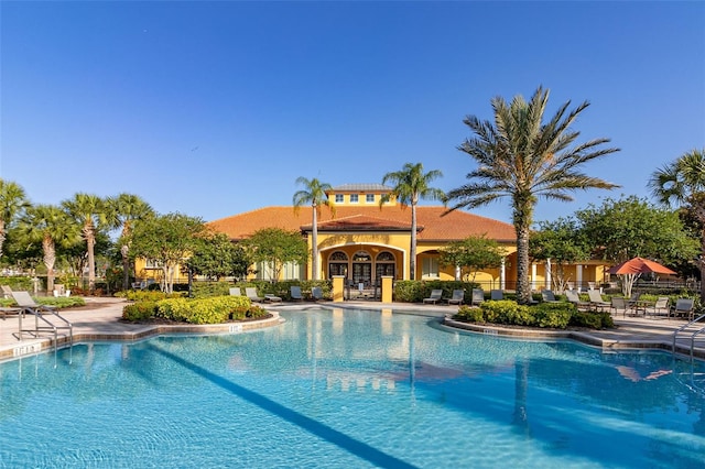 113 Tiger Lily Ct, Davenport, FL 33837 - community pool featuring a patio area
