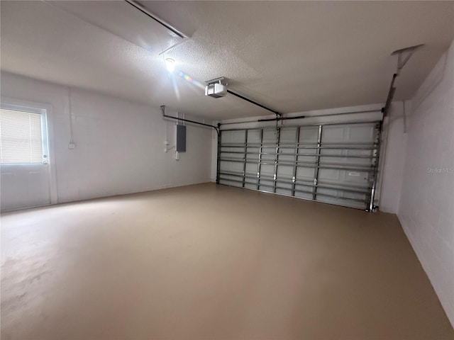 garage with electric panel and a garage door opener