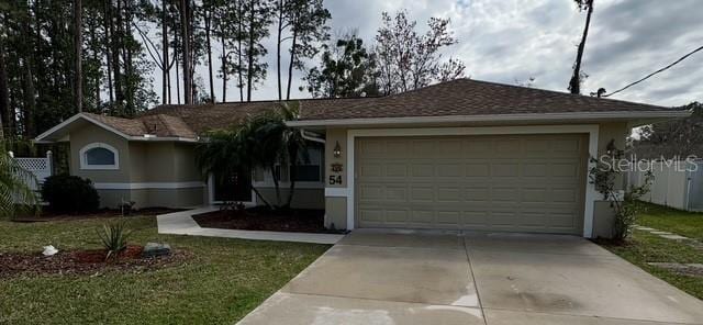 ranch-style home with driveway, an attached garage, and stucco siding