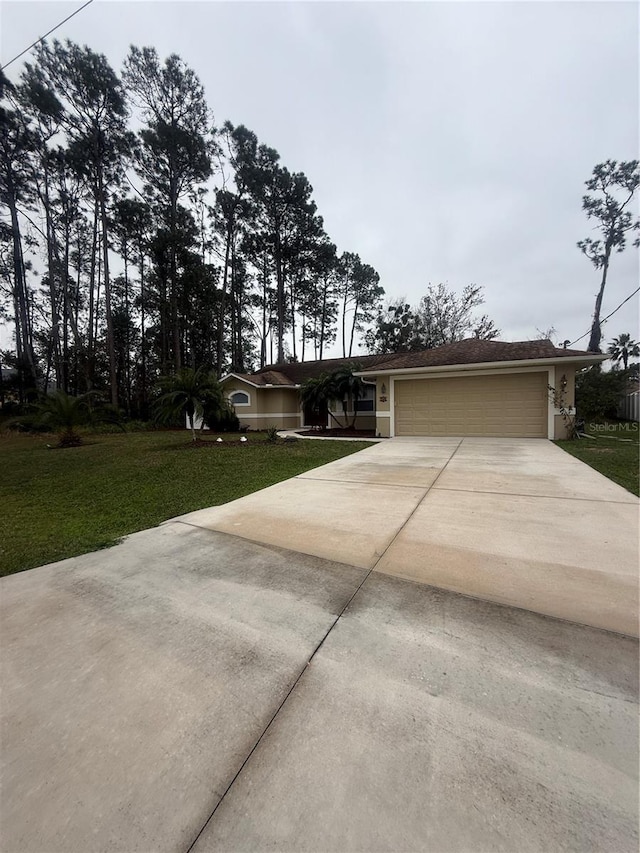 view of front of property with driveway, an attached garage, and a front yard