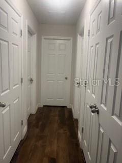 hallway with dark wood-style flooring