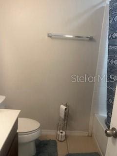 full bath featuring toilet, baseboards, and vanity