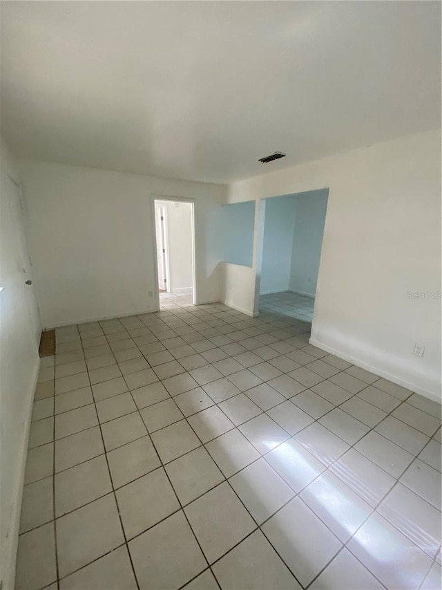 empty room featuring visible vents and light tile patterned floors