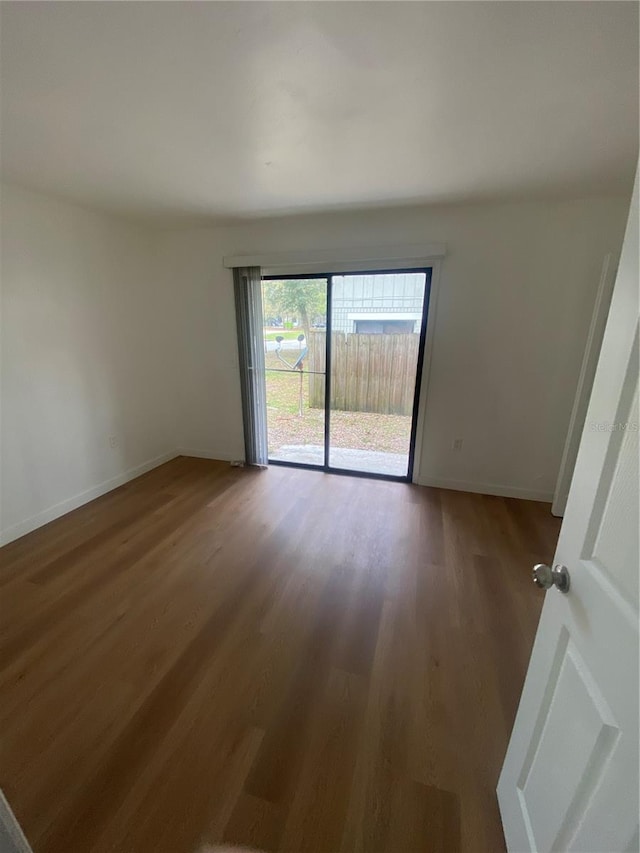 empty room featuring baseboards and wood finished floors