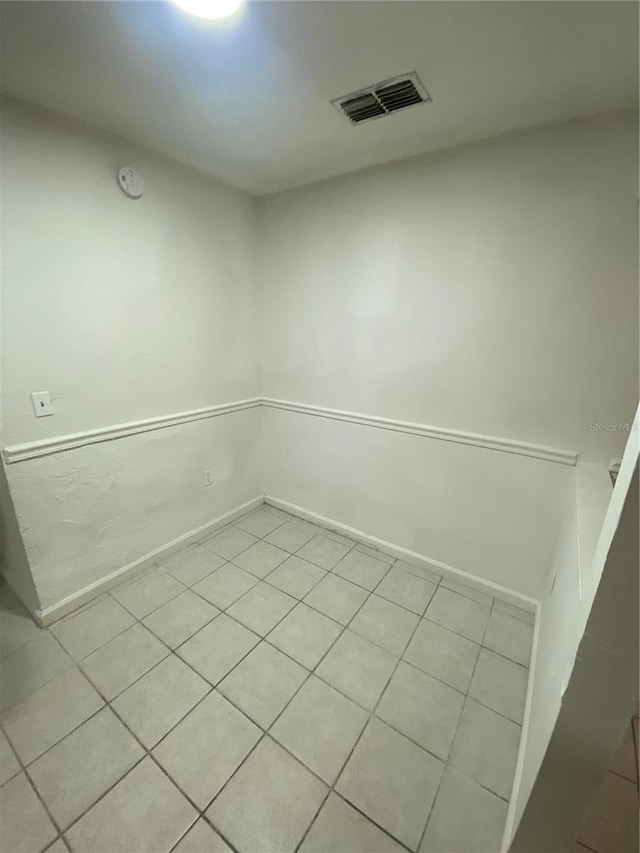 spare room with baseboards and visible vents