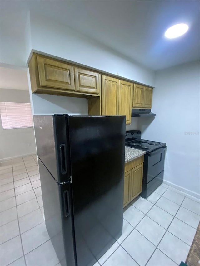 kitchen featuring black appliances, light stone counters, light tile patterned flooring, and brown cabinets