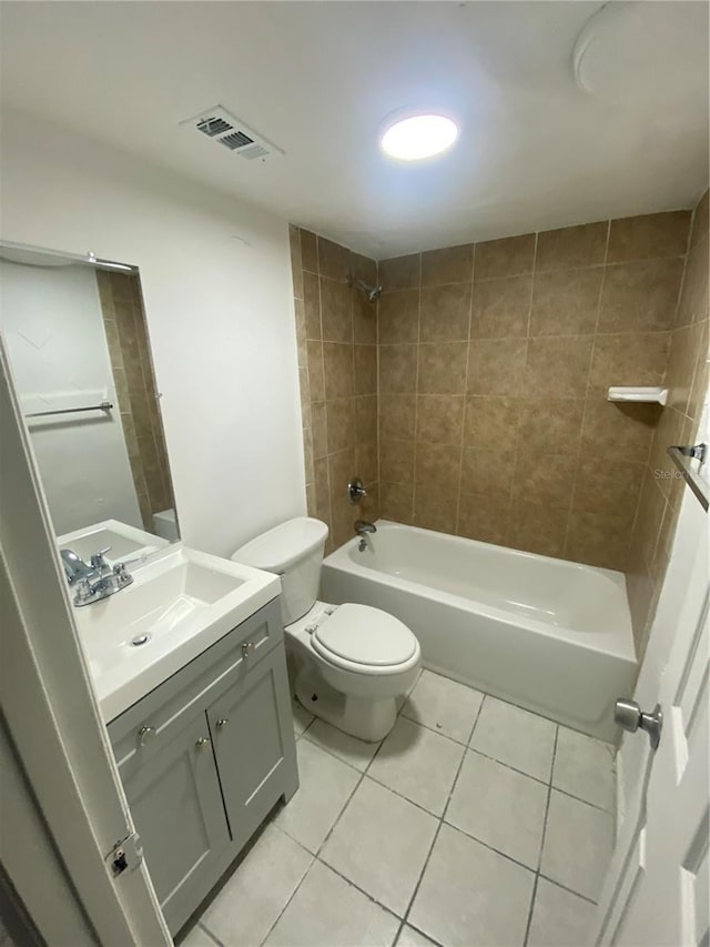 bathroom featuring visible vents, toilet, vanity, shower / tub combination, and tile patterned floors