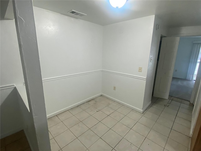 spare room with visible vents, baseboards, and light tile patterned floors