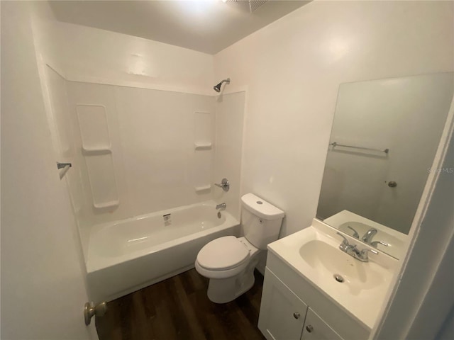 full bath with  shower combination, vanity, toilet, and wood finished floors