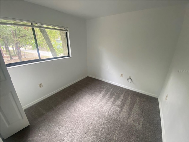 unfurnished room featuring baseboards