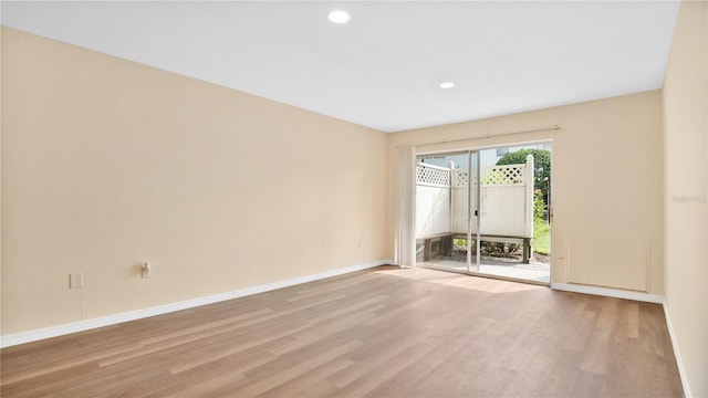 spare room with light wood-style floors, recessed lighting, and baseboards