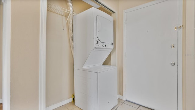 1695 Lee Rd Unit E103, Winter Park, FL 32789 - laundry room with stacked washer / drying machine, light tile patterned floors, and baseboards